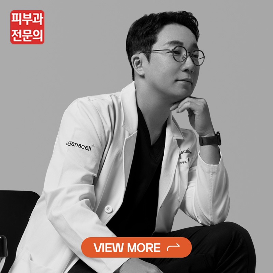 Black-and-white portrait of a man in a lab coat and round glasses, seated with chin resting on his hand; orange 'VIEW MORE' button overlays the image.