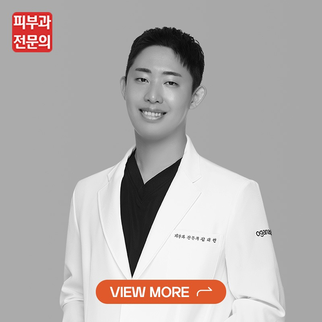 Smiling doctor in a white coat against a gray background, with an orange 'View More' CTA button overlaying the image.